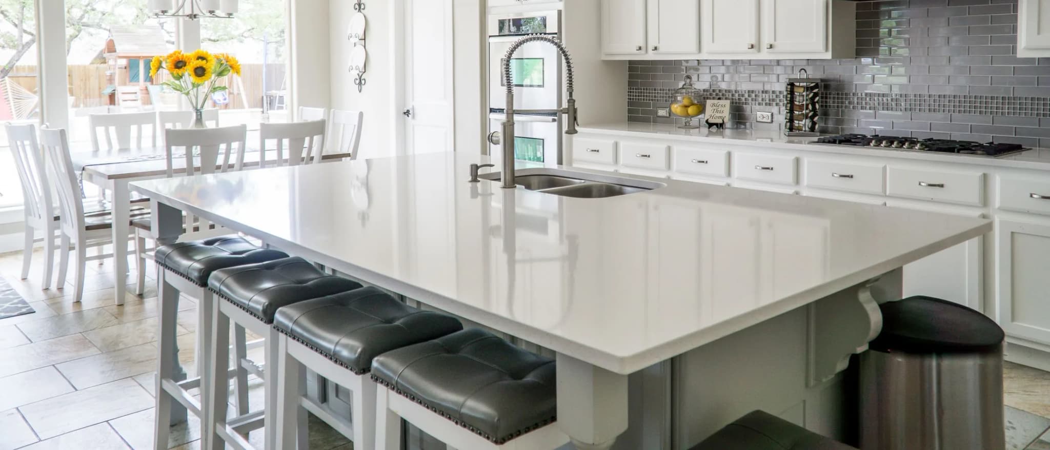 Modern kitchen with stone island and pendant lighting