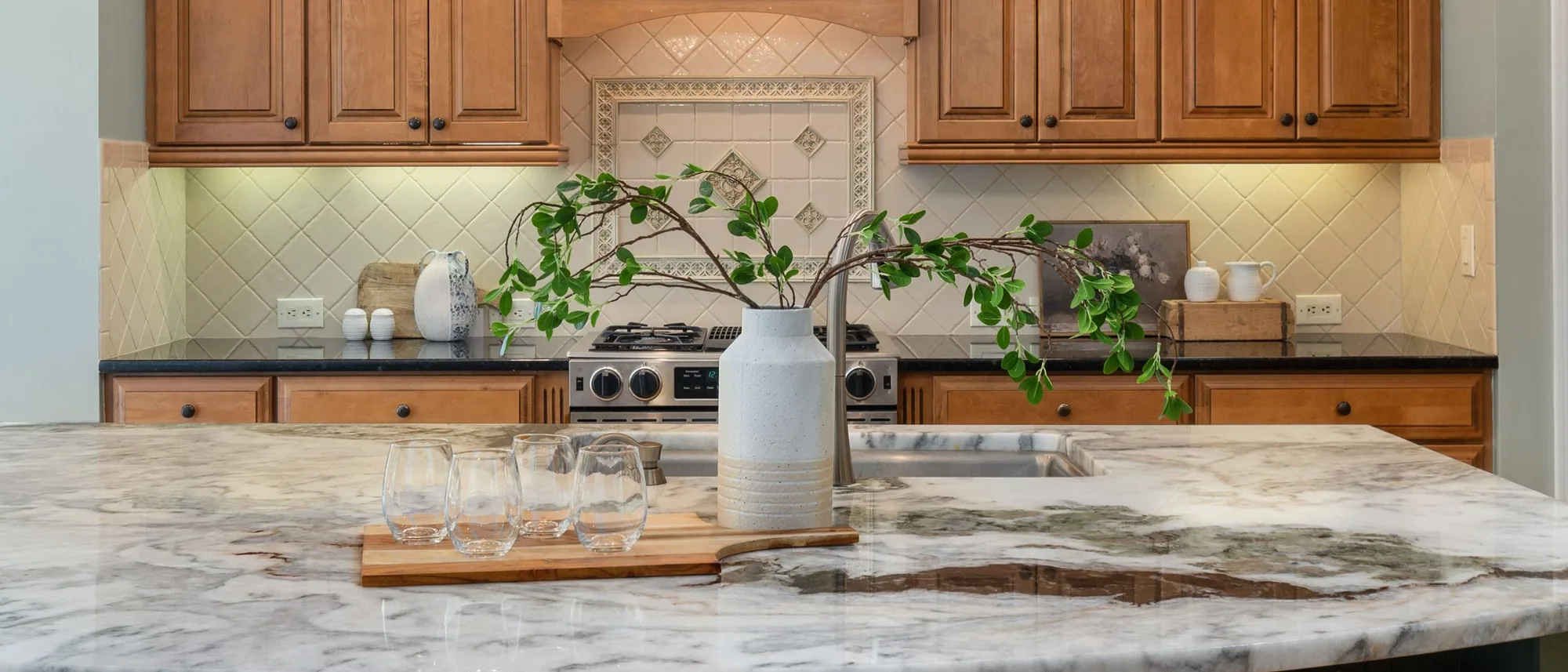 Vintage Splendor kitchen with warm wood cabinetry and marble island